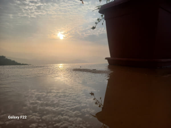 Scenic view of a flower vase against the sky during sunrise