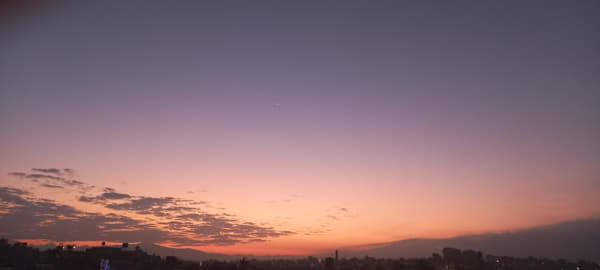 Reddish sky with moon during sunset