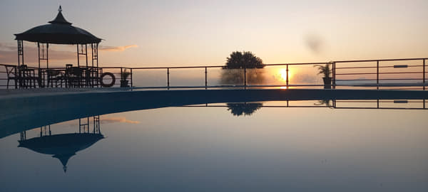 Swimming pool against the sky during sunrise